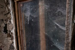 A dusty window offers a glimpse into this structure's interior,
