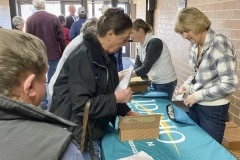 Rolls of newly released Frank Church River of No Return Wilderness quarters are exchanged for cash by the East Idaho Credit Union on Wednesday, Nov. 6, 2019, following a ceremony at Salmon Junior-Senior High School in Salmon, Idaho. The coin is the 50th in the U.S. Mint’s America the Beautiful series of quarters.  (© 2019 Cindi Christie/Cyanpixel)