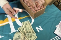 Rolls of newly released Frank Church River of No Return Wilderness quarters are exchanged for cash by the East Idaho Credit Union on Wednesday, Nov. 6, 2019, following a ceremony at Salmon Junior-Senior High School in Salmon, Idaho. The coin is the 50th in the U.S. Mint’s America the Beautiful series of quarters.  (© 2019 Cindi Christie/Cyanpixel)