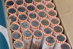 Rolls of newly released Frank Church River of No Return Wilderness quarters are exchanged for cash by the East Idaho Credit Union on Wednesday, Nov. 6, 2019, following a ceremony at Salmon Junior-Senior High School in Salmon, Idaho. The coin is the 50th in the U.S. Mint’s America the Beautiful series of quarters.  (© 2019 Cindi Christie/Cyanpixel)